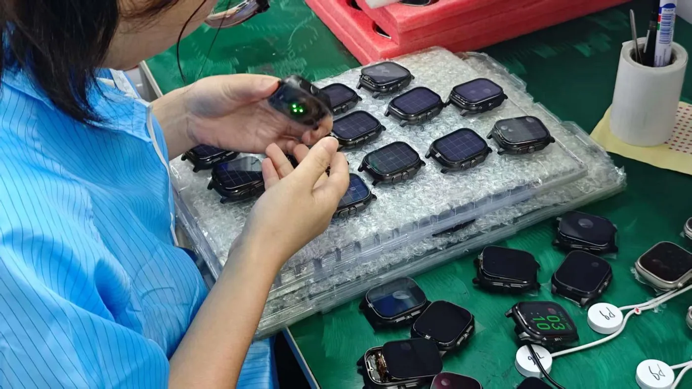 Manual assembly line for smartwatch units at the VitalWatch production base